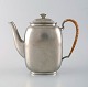 Just Andersen art deco coffee pot in pewter with handle in wicker.
