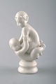 Rare Dahl Jensen figure. Blanc de chine. Faun sitting on baby. Model Number 
1038.
