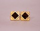 Gilded cufflinks with dark brown stones.
5000m2 showroom.