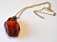 Large polished 
amber jewelery 
with silver 
pendant, 20th 
...