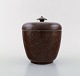 Wilhelm Kåge. Early and rare art deco lidded jar in glazed ceramics. Beautiful 
glaze in brown shades. 1920 / 30