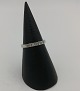 14 karat 
guldring, i 
hvidguld, med 4 
brillanter, 
samlet ca. 0.04 
ct
Ringstr. 51.5 
Ø ...