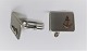 Silver 
cufflinks (835) 
with gilt 
anchor. Length 
20 mm.