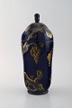 Karl Lindström and Nils Emil Lundström for Rörstrand. Lidded porcelain jar 
decorated with grape vines in gold on beautiful dark blue base. Japanism, ca. 
1920.
