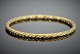 Georg Jensen; A 
braided bangle 
of 18k gold 
#1017A