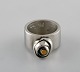 Micke Berggren, 
Sverige. 
Modernistisk 
ring i tin og 
messing. Sent 
1900-tallet. 
Diameter: 16,2 
...