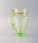 Emile Gallé (1846-1904). Tidlig og sjælden kande i mundblæst lysegrønt kunstglas 
med håndmalede guldekorationer i form af blade. Museumskvalitet, 1870/80