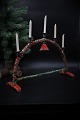 Swedish Christmas candlestick from around the year 1900 in Fil de fer / metal 
wire decorated with red and green tissue paper.
H:29.5cm. 
W:42cm. D:12cm.

