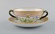 Royal Copenhagen Flora Danica boullion cup with saucer in hand-painted porcelain 
with branch-shaped handles, flowers and gold decoration. Model number 20/3612.
