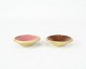A set of 
ceramic salt 
jars with red 
and light pink 
glaze.
2 x 13,5 cm.

