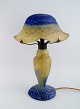 Daum Nancy, France. Large art deco "Verre de jade" table lamp in blue and green 
mouth blown art glass with leaf-shaped screen holder. Dated 1919-23.
