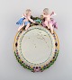 Antique Meissen porcelain mirror with original glass. Decorated with angels and 
repousse flowers. 19th century.
