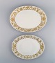 Bjørn Wiinblad 
for Rosenthal. 
To ovale 
serveringsfade 
i porcelæn med 
gulddekoration. 
...