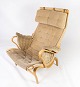 The Pernilla 
armchair, 
designed by 
Bruno Mathsson 
and 
manufactured by 
Dux during the 
1960s, ...