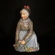 Carl Martin 
Hansen for 
Royal 
Copenhagen; A 
porcelain 
figurine of a 
Fanø girl 
#12413. First.
H. ...