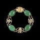 Armbånd i 14k 
guld med Jade.
Stemplet 14k.
L. 18,5 cm. 
B. 1,3 cm.
Vægt 13,8 g.
Brugt i god 
...