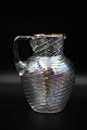 Old glass jug 
with handle in 
twisted glass 
with gold edge. 

Height: 19cm.