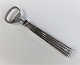 Champagne. 
Silver cutlery 
(830). Capsule 
opener. Length 
14.5 cm.