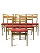 Six dining room 
chairs in dark 
polished wood 
and upholstered 
with red 
fabric, of 
Danish design 
...