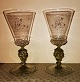 Pair of wine 
glasses with 
green stem and 
foot in pressed 
green glass. 
Owner initials 
on the cup. ...
