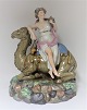 Royal 
Copenhagen. 
Porcelænsfigur. 
Kvinde på 
dromedar. Fra 
serien "De fire 
verdensdele " 
Asien. ...