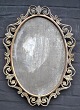 Spejl, 19. årh. Bronze og bronzeret jernramme. Oval. H.: 62 cm. B.: 45 cm.NB: Spejglas mangler. . 