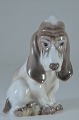 Jagthund Dahl 
Jensen 
porcelænsfigur, 
siddende hvalp, 
bassethund nr. 
1065. Højde 
14,5 cm. 1. ...