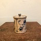 Jesper Packness 
cylindrical jar 
with clay lid. 
Decorated with 
blue fluted 
patterns. H. 
12.5 cm. ...