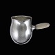 Georg Jensen. 
Mælkekande i 
hammerslået 
sterling sølv 
#80A.
Greb i 
elfenben.
Tegnet år 1915 
af ...