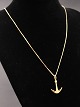 14 karat 
guldkæde 45 cm. 
med Ole 
Lynggaard 
Vintage vedhæng 
af 14 karat 
guld udført som 
anker 2,3 ...