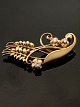 GEORG JENSEN 
vintage 18 
karat guld 
broche design 
#35 med 3 
brilliant 
slebne 
diamanter 4,3 x 
2 ...