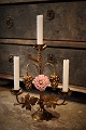 Old French church candlestick in gilded bronze decorated with 1 fine old colored 
porcelain flower. 
H: 33cm. 
W: 28cm.
