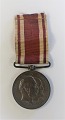 Danmark. 
Medalje. For 
deltagelse i 
krigene 1848-50 
& 1864. 
Diameter 3 cm.