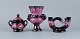 Vallauris, 
France, Lidded 
bowl, two-armed 
candlestick and 
a vase. 
Luster glaze.
1960/70s.
In ...