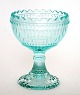 Iittala, 
Finland, 
Marimekko, Skål 
på fod, opsats 
i vandgrøn 
presset glas. 
Højde 12 cm. 
Øverste ...