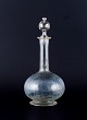 Dansk glasværk, 
mundblæst 
vinkaraffel i 
klart glas. 
Ca. 1900.
I flot stand.
Mål: H 27,5 x 
D ...