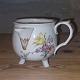 Kande i 
porcelæn fra 
Royal 
Copenhagen. 
Fremstillet 
omkring 1800. 
Dekoreeret med 
blomster. ...