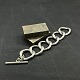 Længde 22 cm.
Bredde 4 cm.
Tungt armbånd 
i forsølvet 
metal fra 
1960'erne.
Det består af 
6 ...