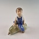 Figur af porcelæn formgivet som en dreng siddende på græskar. No 4539Producent Royal ...