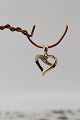 Heart-shaped pendant in 14 carat gold, with diamonds. Stamped 585 BEE. Very 
exclusive.