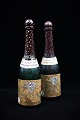 Dekorativ , 
gammel 
champagne 
flaske , drejet 
i træ , hul 
indeni med låg 
i bunden. H: 
26,5cm. ...