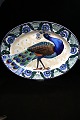 Large, beautiful oval dish from Aluminia with peacock motif. 
736/632. 
61.5 x 44.5 cm...
