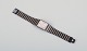 Omega De Ville 
herrearmbåndsur 
i messing og 
sort metal.
1980’erne.
Alle dele er 
...