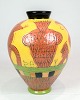 The vase, 
designed and 
hand painted by 
Lene Regius 
with yellow, 
orange and 
green glaze, is 
an ...