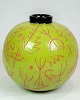 Lene Regius' 
round vase with 
black top, 
green glaze and 
orange 
patterned 
engravings from 
around ...