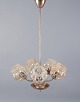 Helena Tynell 
(1918-2016), 
finsk designer.
Femarmet 
loftslampe i 
messing med 
røgfarvede ...