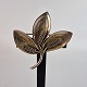 Broche af 
sterling sølv, 
udformet som 3 
blomster
Designer Aarre 
& Krogs Eftf., 
Randers (1949 
...