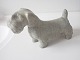Arne Bang (1901 
- 1983). 
Stående skotte 
hund i stentøj 
med lys grålig 
glaser. 
Signeret AB 
210. ...