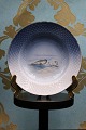 Bing & Grøndahl 
lille dyb 
tallerken med 
grønlandske 
motiver 
og med 
guldkant. Dia.: 
21,5cm. ...