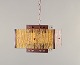 Venhola, Finland. Ceiling lamp in brass and amber-colored glass.